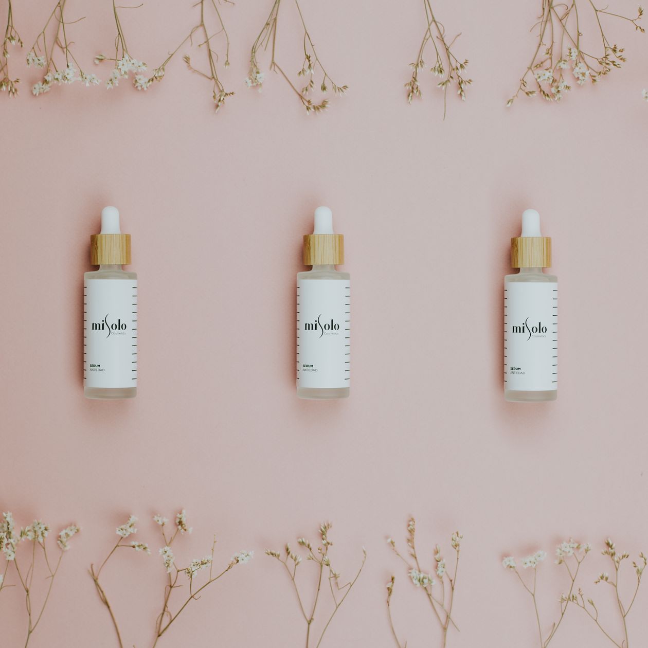 LumaLift dropper bottles styled on pink background