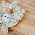 LumaLift Bio-Collagen Glow Mask styled with flowers