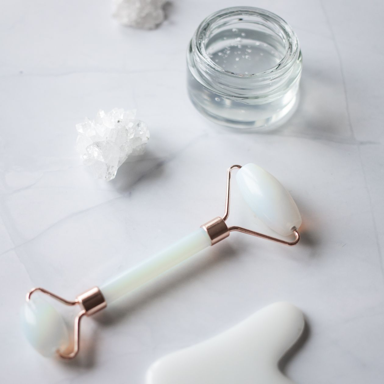 LumaLift beauty roller and cream jar on marble